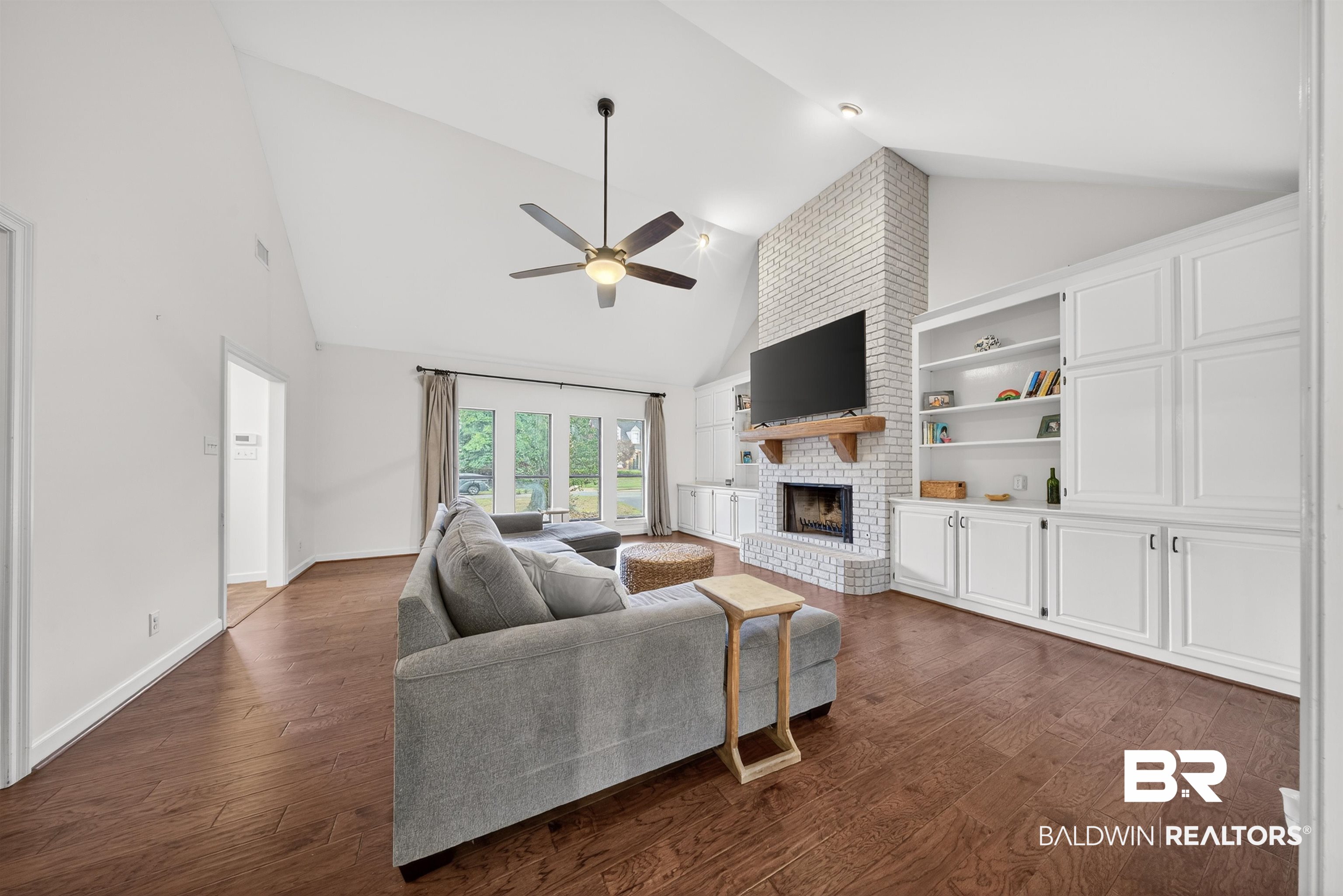 1250 Savannah Drive Mobile, AL 36609 - Photo 10 of 35 Living area with a fireplace, dark wood-type flooring, lofted ceiling, and a ceiling fan