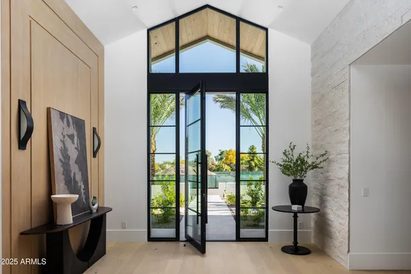 a living room with furniture and a floor to ceiling window