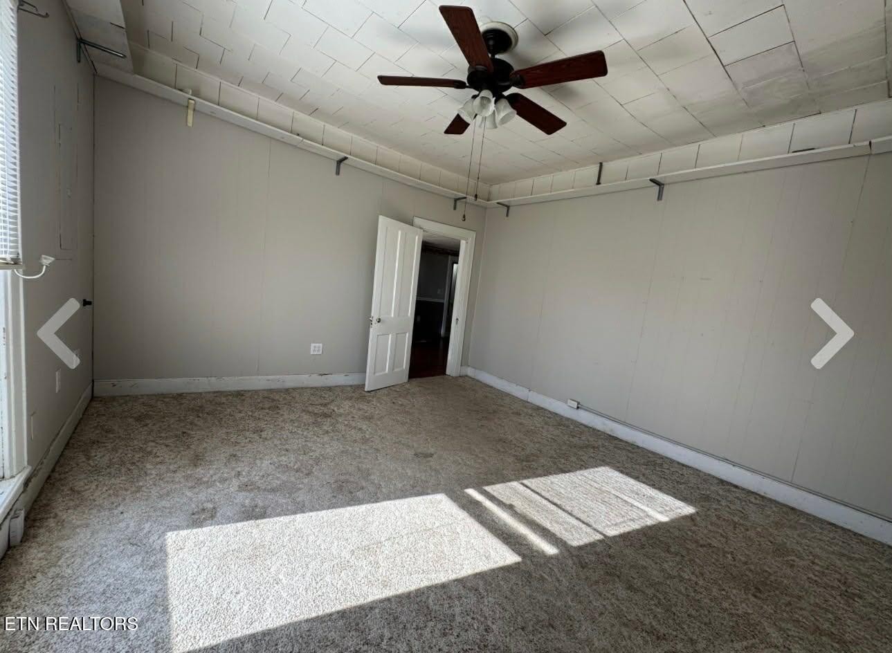 1200 North Church Street Portland, TN 37148 - Photo 12 of 17 an empty room with a ceiling fan and carpet