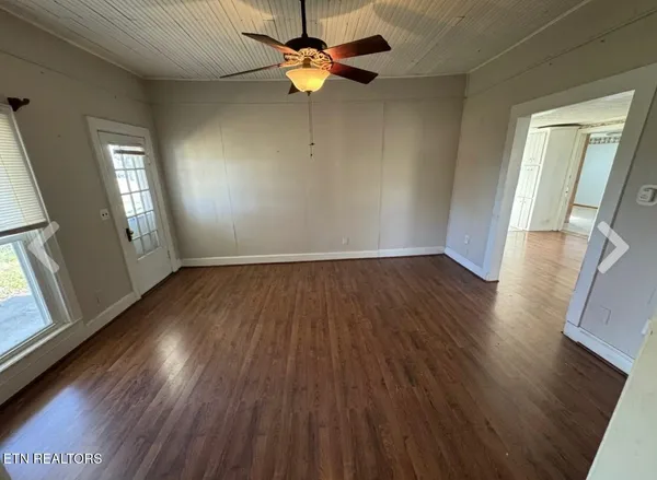 wooden floor in an empty room with a window