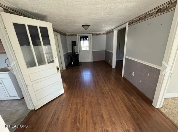 a view of front door with wooden floor and stairs