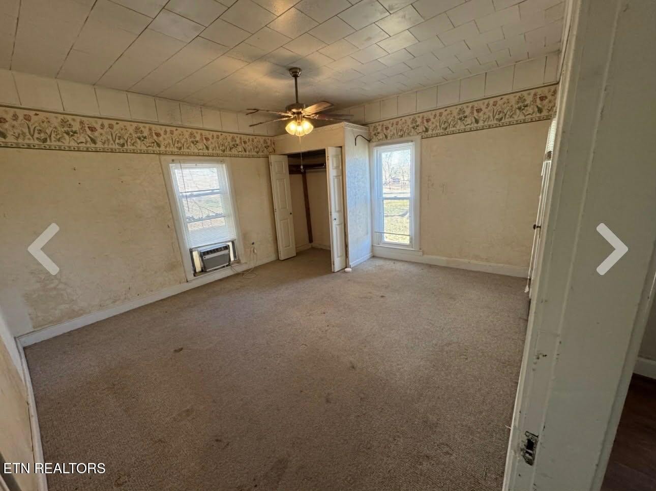 1200 North Church Street Portland, TN 37148 - Photo 10 of 17 en empty room with windows and ceiling fan
