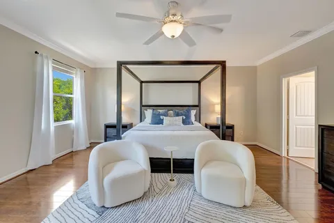 a bedroom with a bed and a chandelier