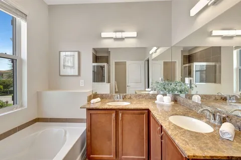 a bathroom with a tub sink and mirror