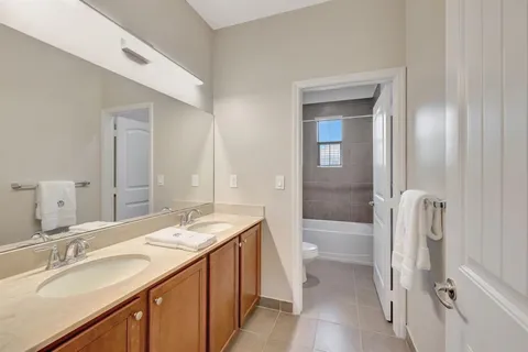 a bathroom with a sink and mirror with toilet