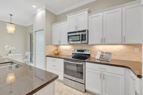 a kitchen with stainless steel appliances granite countertop a sink stove and microwave