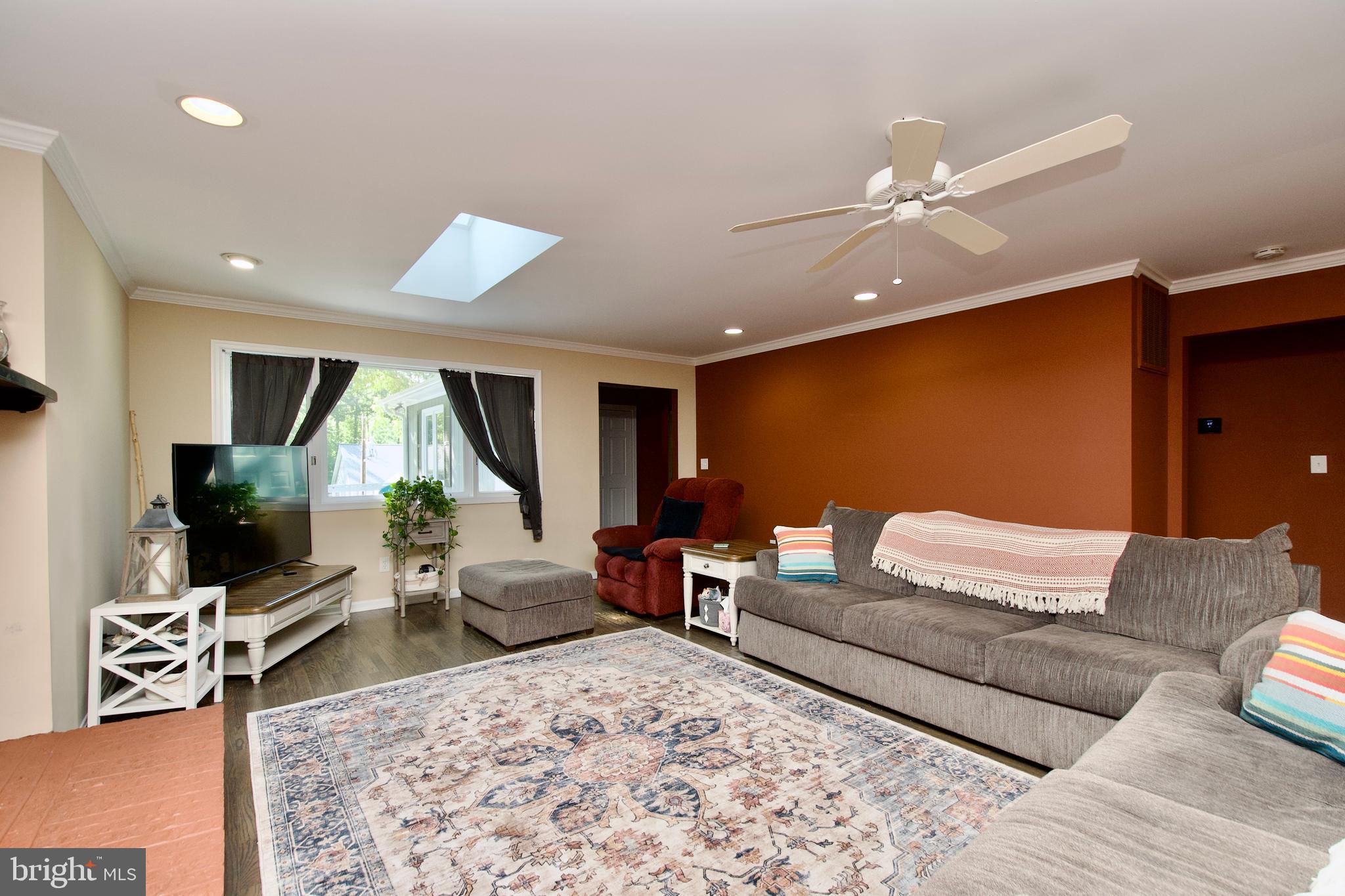 703 Gold Valley Road Locust Grove, VA 22508 - Photo 2 of 10 a living room with furniture and a flat screen tv