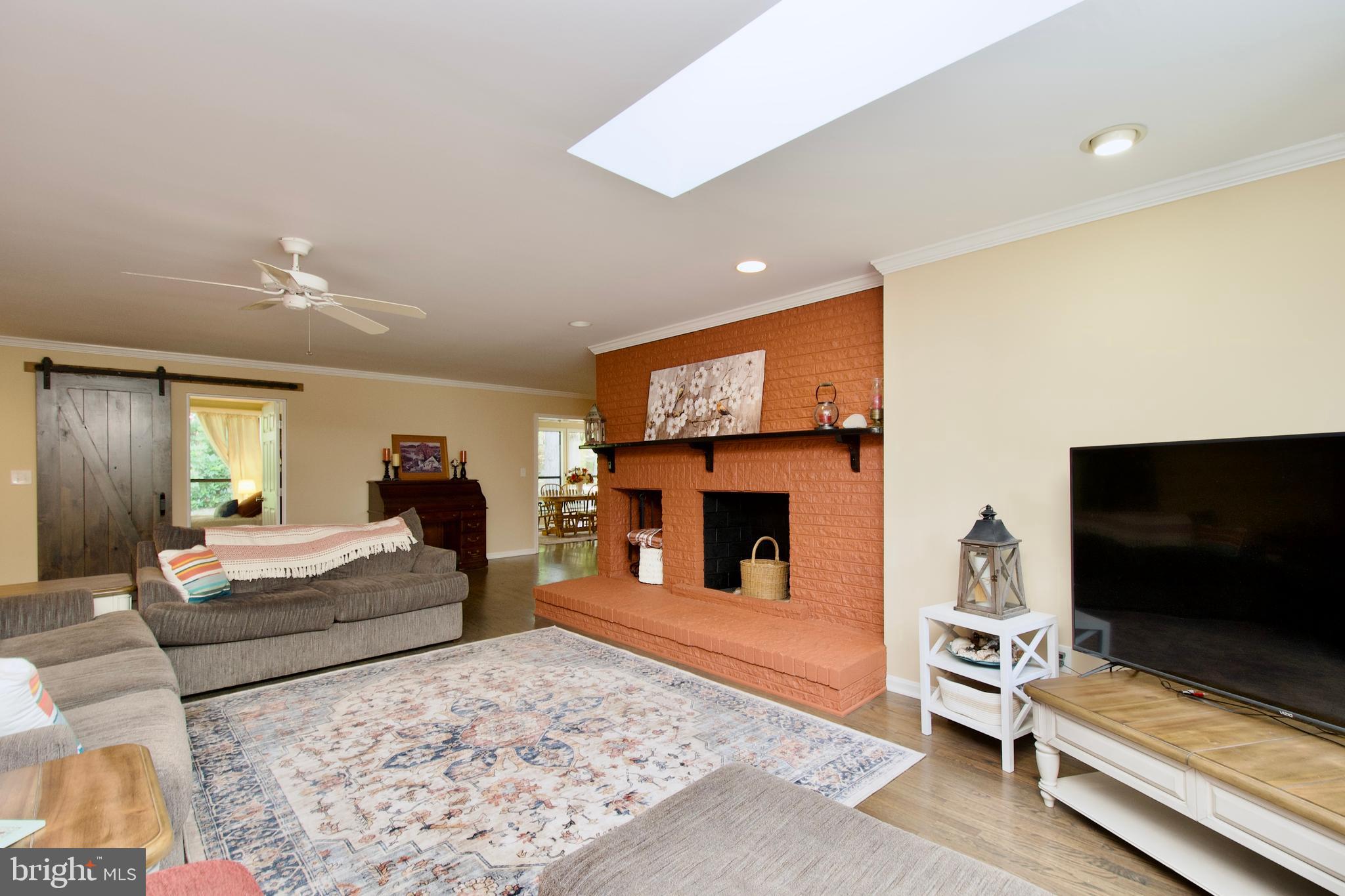 703 Gold Valley Road Locust Grove, VA 22508 - Photo 3 of 10 a living room with fireplace furniture and a flat screen tv