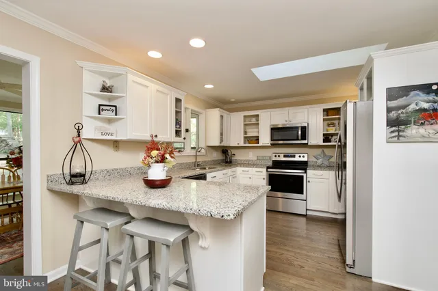 a kitchen with stainless steel appliances granite countertop a sink and cabinets