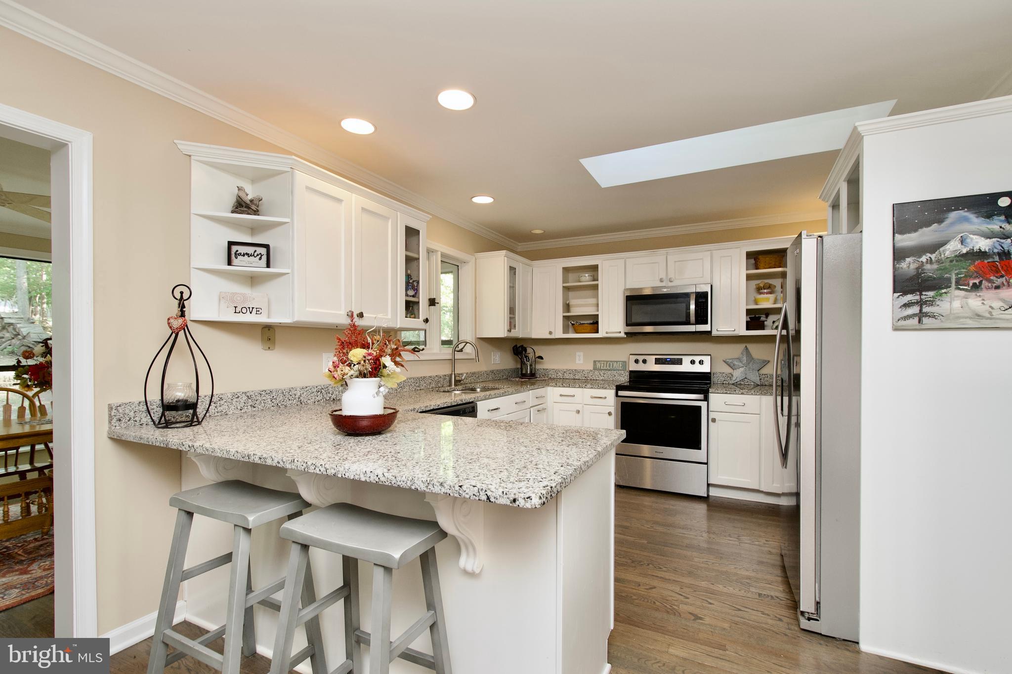 703 Gold Valley Road Locust Grove, VA 22508 - Photo 4 of 10 a kitchen with stainless steel appliances granite countertop a sink and cabinets
