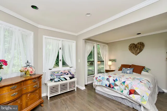 a bedroom with bed and wooden floor