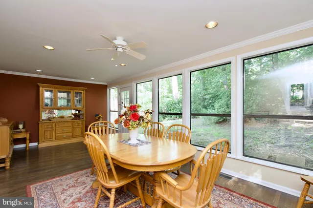 a dining room with furniture window and wooden floor