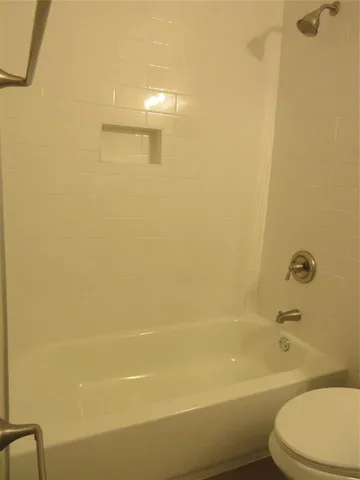 a bathroom with a bathtub and a toilet
