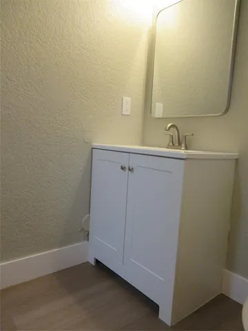 a bathroom with a sink and mirror