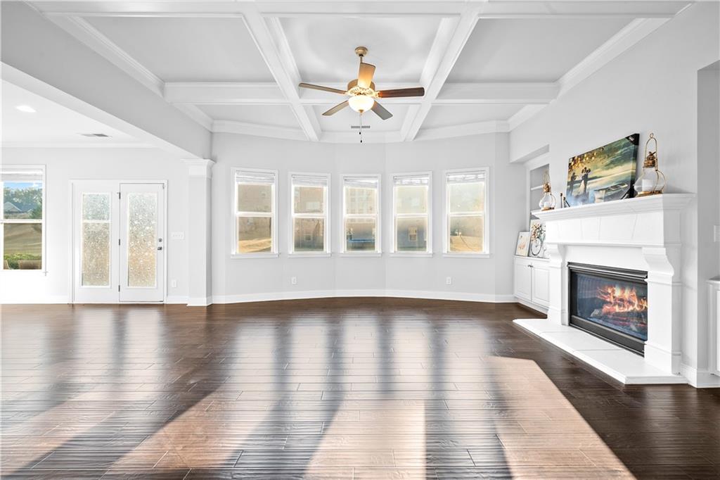 2770 Longacre Park Way Lawrenceville, GA 30044 - Photo 11 of 52 a view of an empty room with wooden floor fireplace and a window