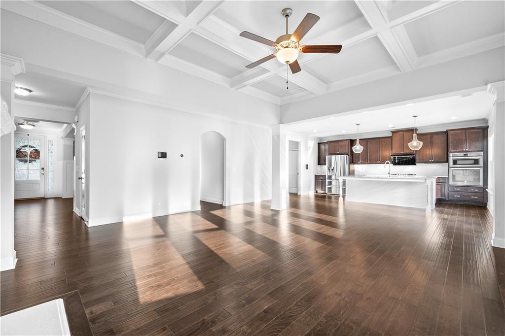 2770 Longacre Park Way Lawrenceville, GA 30044 - Photo 14 of 52 a view of a livingroom with hardwood floor and a ceiling fan