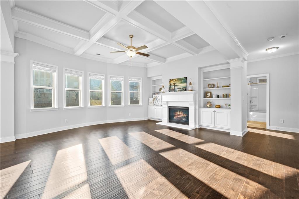 2770 Longacre Park Way Lawrenceville, GA 30044 - Photo 15 of 52 a view of a livingroom with a fireplace a chandelier and wooden floor