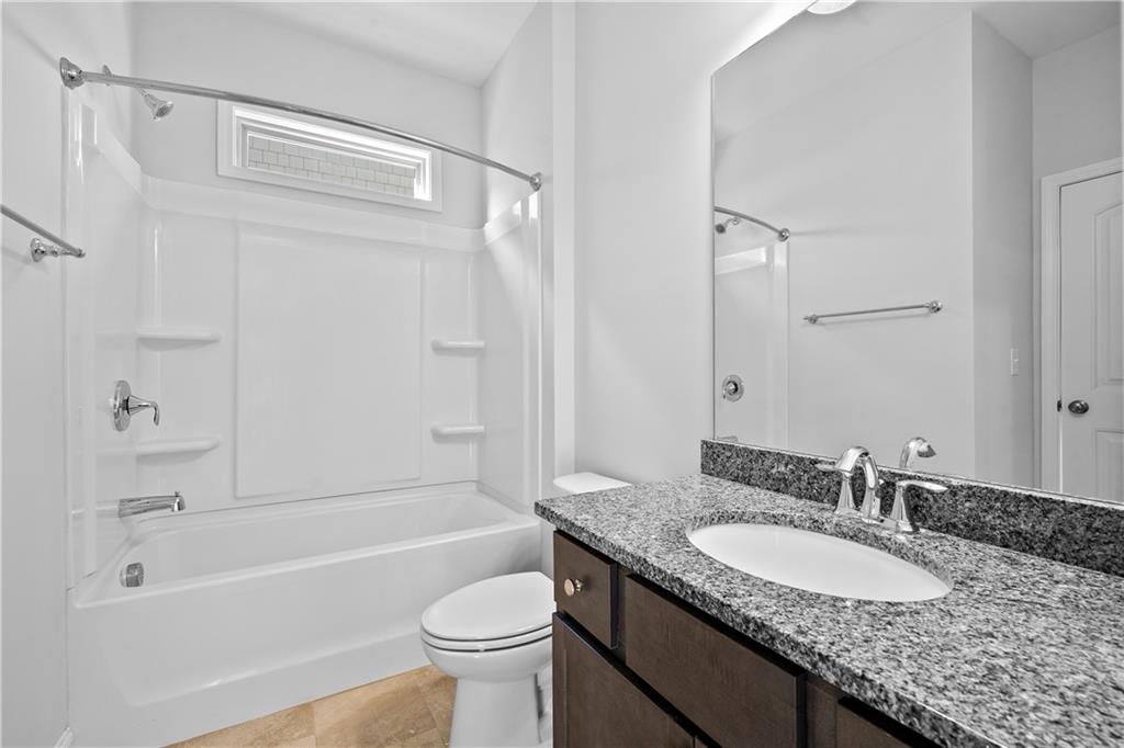 2770 Longacre Park Way Lawrenceville, GA 30044 - Photo 23 of 52 a bathroom with a granite countertop sink toilet and shower