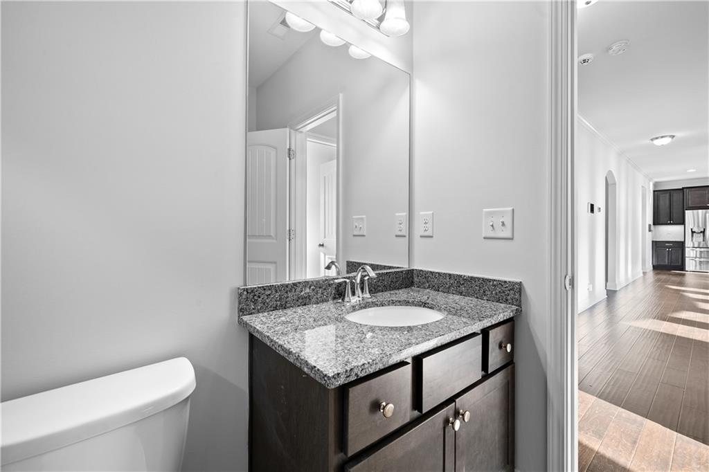 2770 Longacre Park Way Lawrenceville, GA 30044 - Photo 24 of 52 a bathroom with a granite countertop sink and a toilet