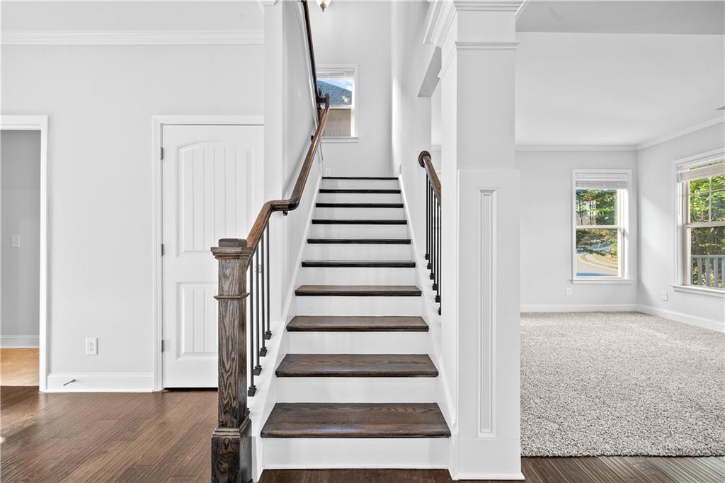 2770 Longacre Park Way Lawrenceville, GA 30044 - Photo 25 of 52 a view of an entryway with wooden floor and staircase