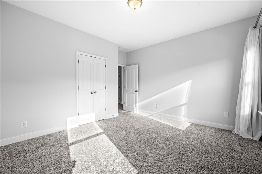 2770 Longacre Park Way Lawrenceville, GA 30044 - Photo 41 of 52 an empty room with a windows and closet