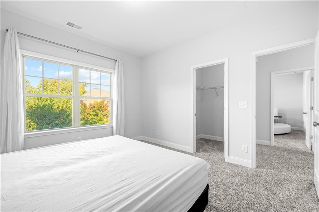 2770 Longacre Park Way Lawrenceville, GA 30044 - Photo 43 of 52 a bedroom with a bed and a large window