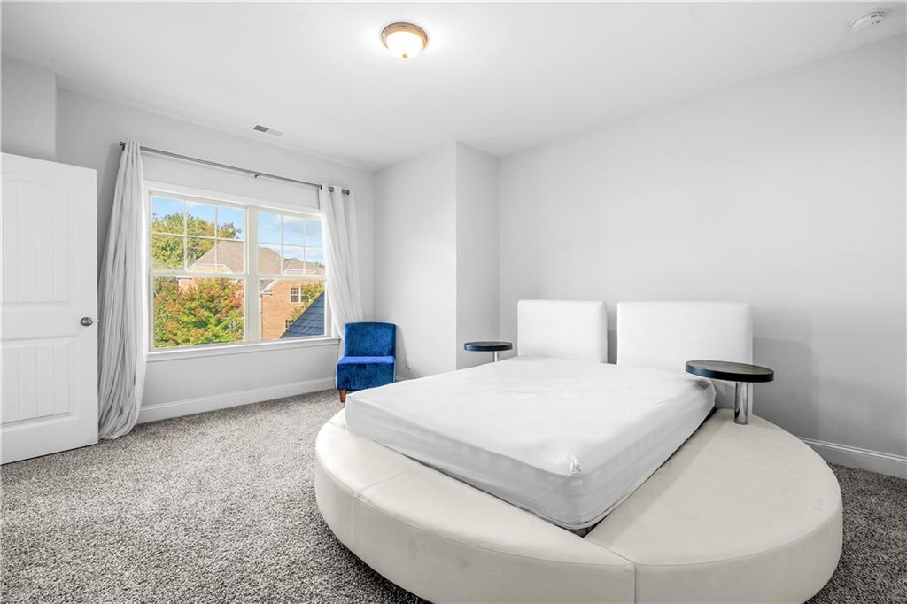 2770 Longacre Park Way Lawrenceville, GA 30044 - Photo 44 of 52 a bedroom with a bed and window