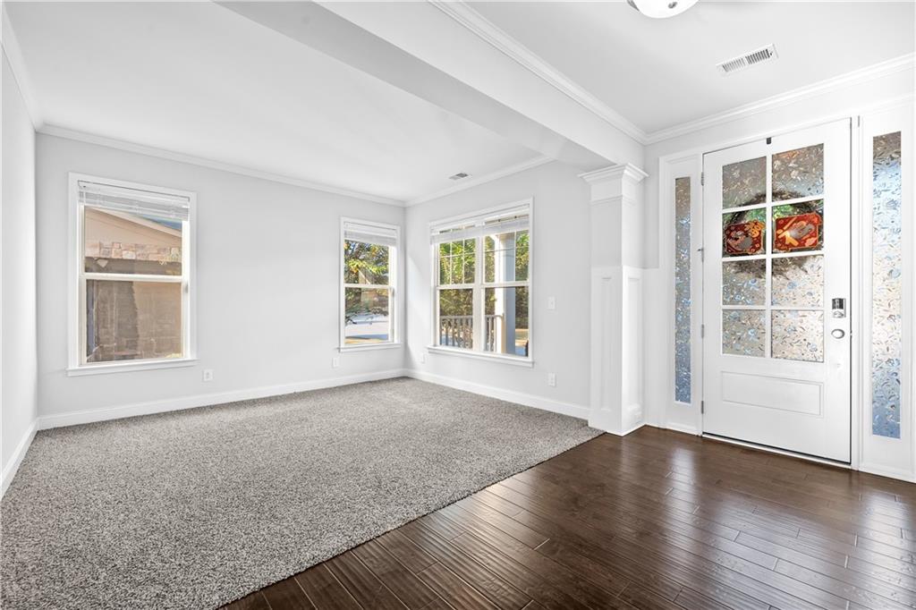 2770 Longacre Park Way Lawrenceville, GA 30044 - Photo 5 of 52 a view of an empty room with a window and wooden floor