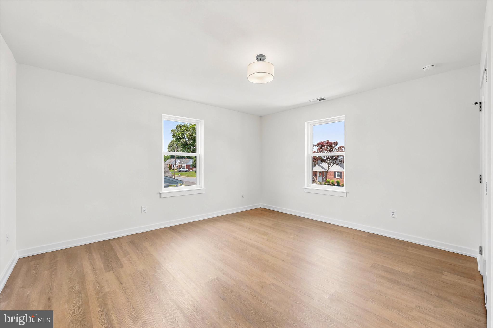 8 James Road Broomall, PA 19008 - Photo 27 of 35 a view of an empty room with wooden floor and a window