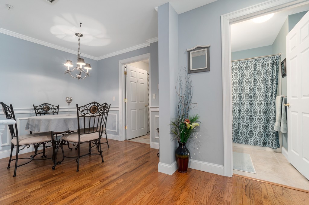 19 Broad Street, Unit 203 Merrimac, MA 01860 - Photo 12 of 20 a dining room with furniture potted plants and wooden floor