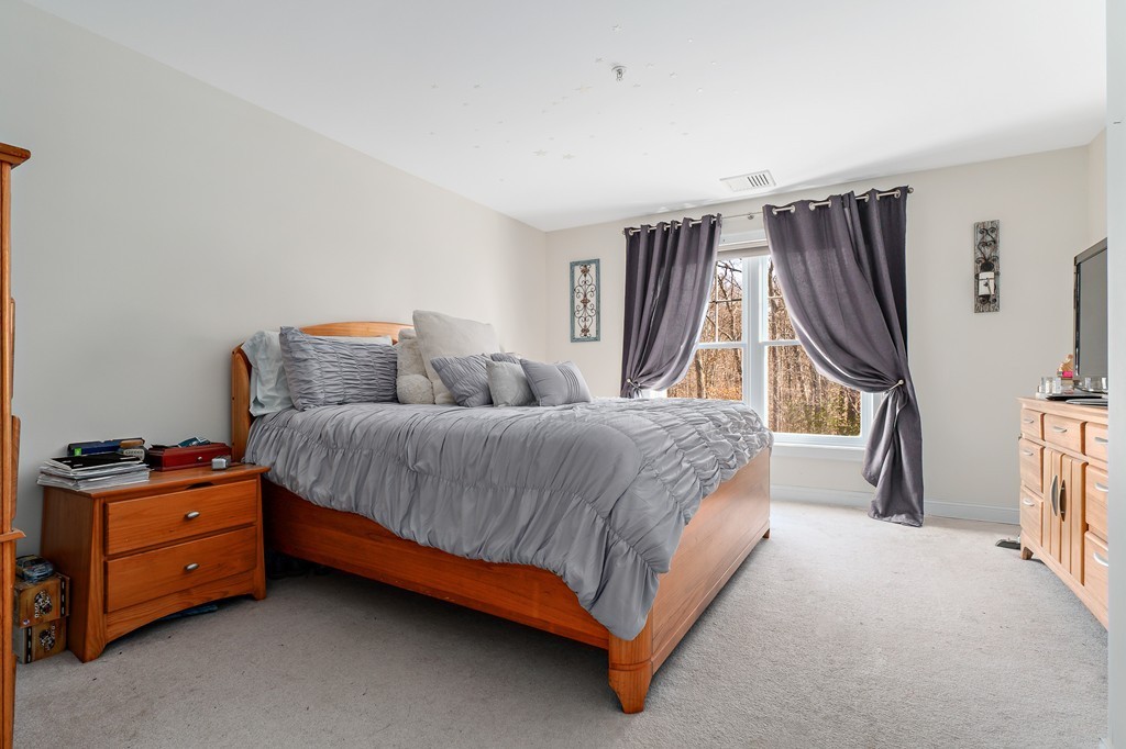 19 Broad Street, Unit 203 Merrimac, MA 01860 - Photo 14 of 20 a bedroom with a bed dresser and a window