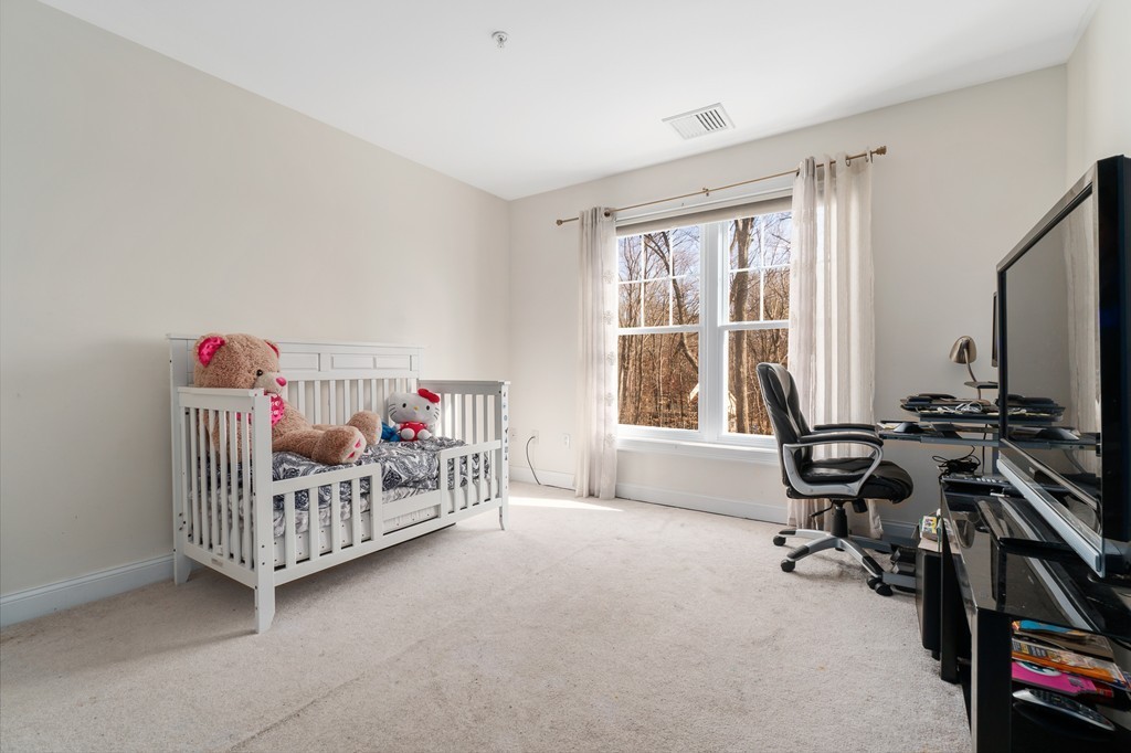 19 Broad Street, Unit 203 Merrimac, MA 01860 - Photo 16 of 20 a bedroom with furniture and a window