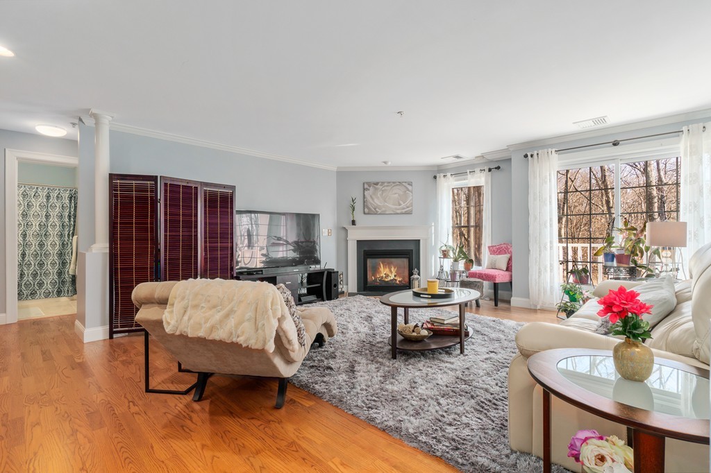 19 Broad Street, Unit 203 Merrimac, MA 01860 - Photo 3 of 20 a living room with furniture dining table and a fireplace