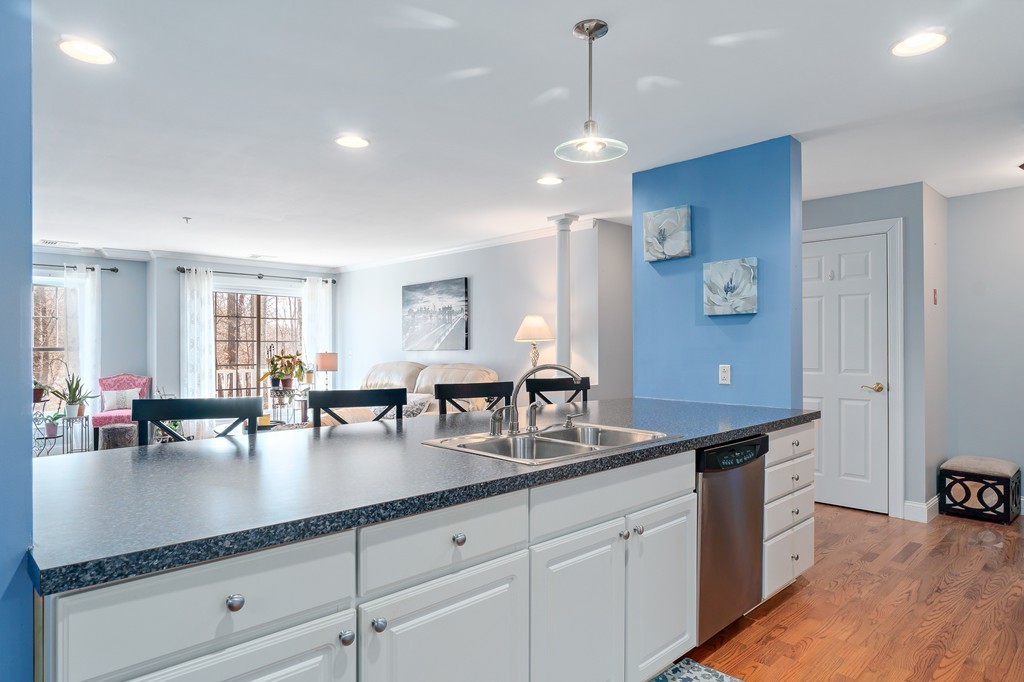 19 Broad Street, Unit 203 Merrimac, MA 01860 - Photo 8 of 20 a kitchen with granite countertop lots of counter space dining table and chairs