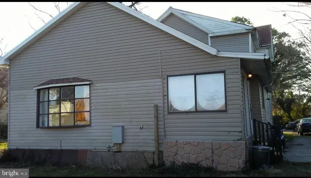 a view of brick house with a small yard