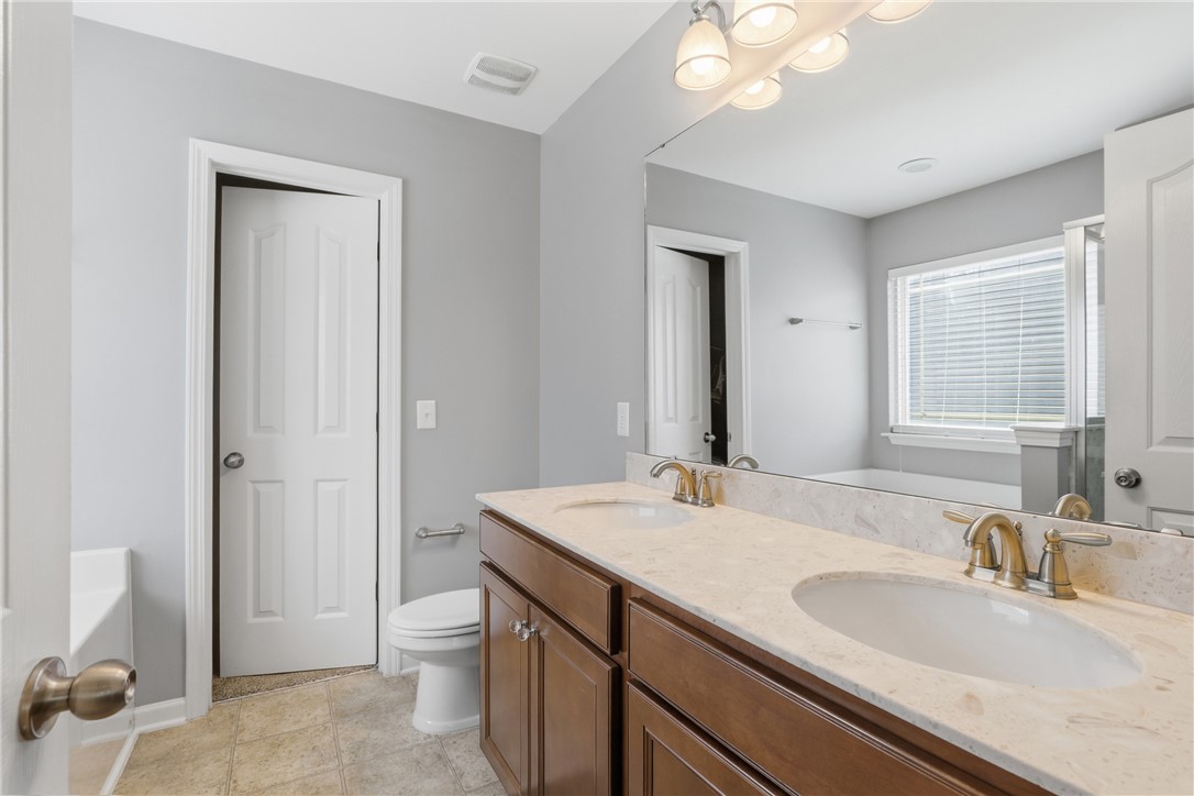 347 Riverdale Road Simpsonville, SC 29680 - Photo 12 of 30 This bathroom features a double vanity and sleek fixtures, perfect for daily routines.