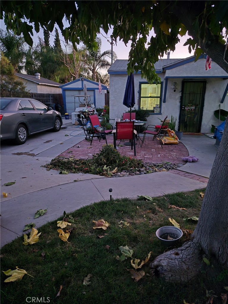 a view of a backyard with table and chairs and potted plants
