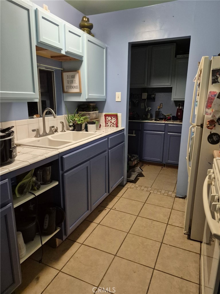 4010 Witt Avenue Riverside, CA 92501 - Photo 8 of 10 a kitchen with a sink a stove and cabinets
