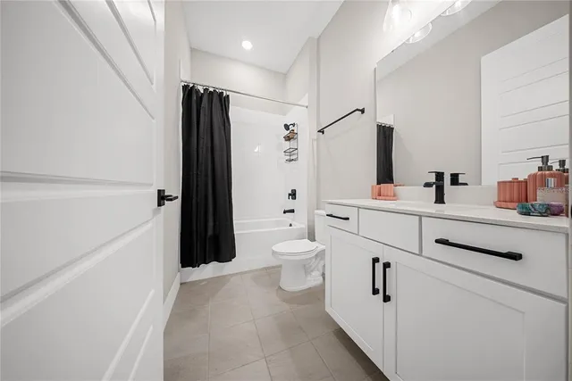 a spacious bedroom with a bed and a window