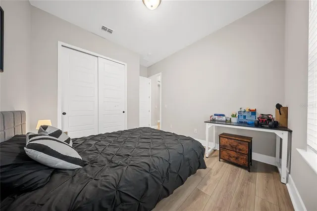 a spacious bathroom with a double vanity sink a toilet a mirror and shower