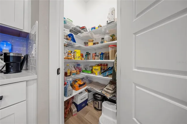 a bedroom with a bed and a large mirror on dresser