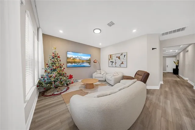a large white bathroom with a large mirror shower and bathtub