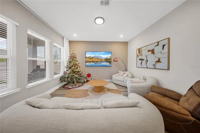 a living room with furniture and a large window