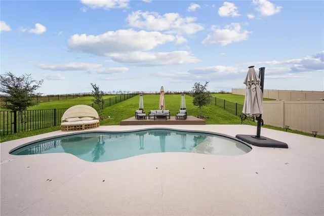 a view of a swimming pool with brick walls and couches