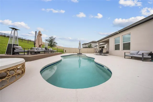an aerial view of a residential houses with outdoor space