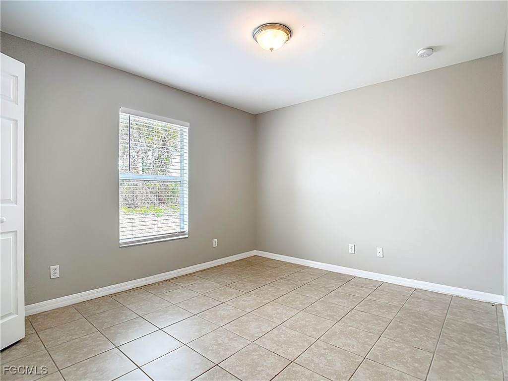 4034 29th Street Southwest Lehigh Acres, FL 33976 - Photo 11 of 22 an empty room with windows