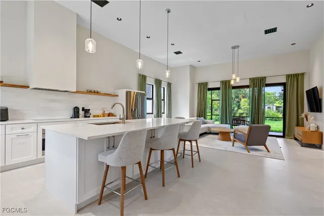 a kitchen with stainless steel appliances granite countertop a sink a stove and a refrigerator