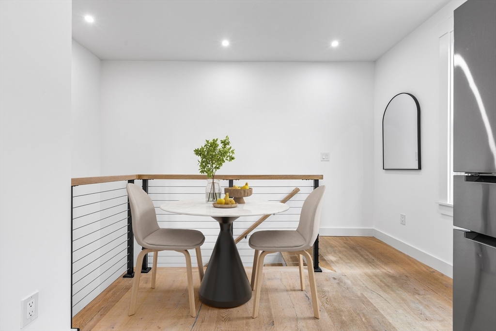 360 Athens Street, Unit 360 Boston, MA 02127 - Photo 7 of 27 a view of a dining room with furniture and wooden floor