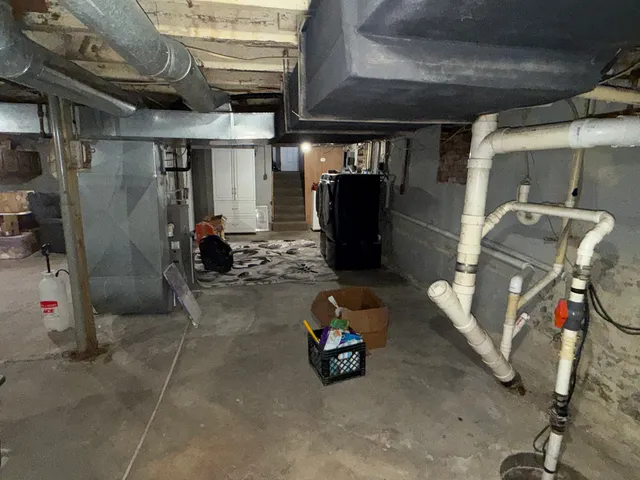 a room with water heater and a utility room