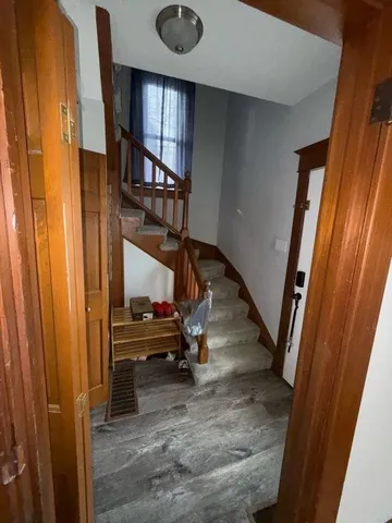 a bathroom with a granite countertop toilet and a sink